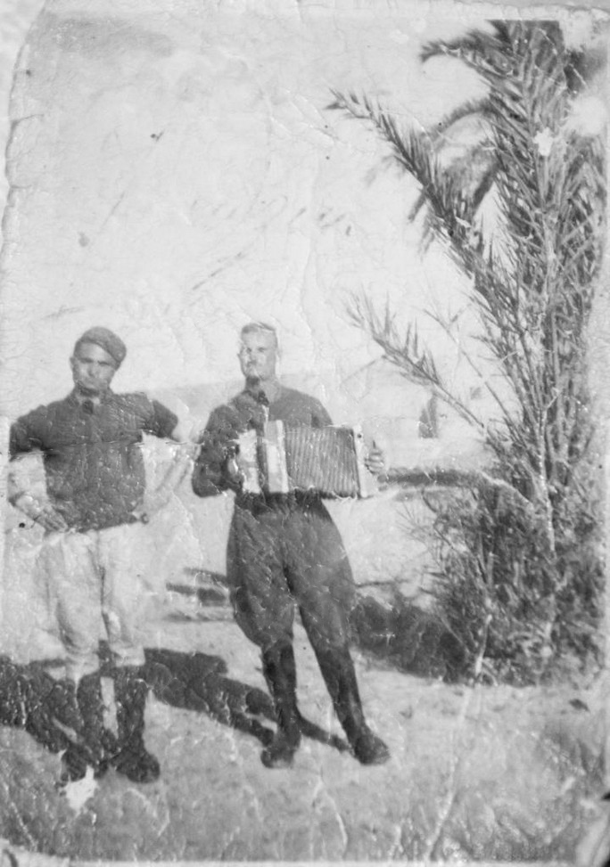 Giuseppe Torcasio playing a diatonic button accordion which he used to entertain the soldiers. WWII North Africa World W